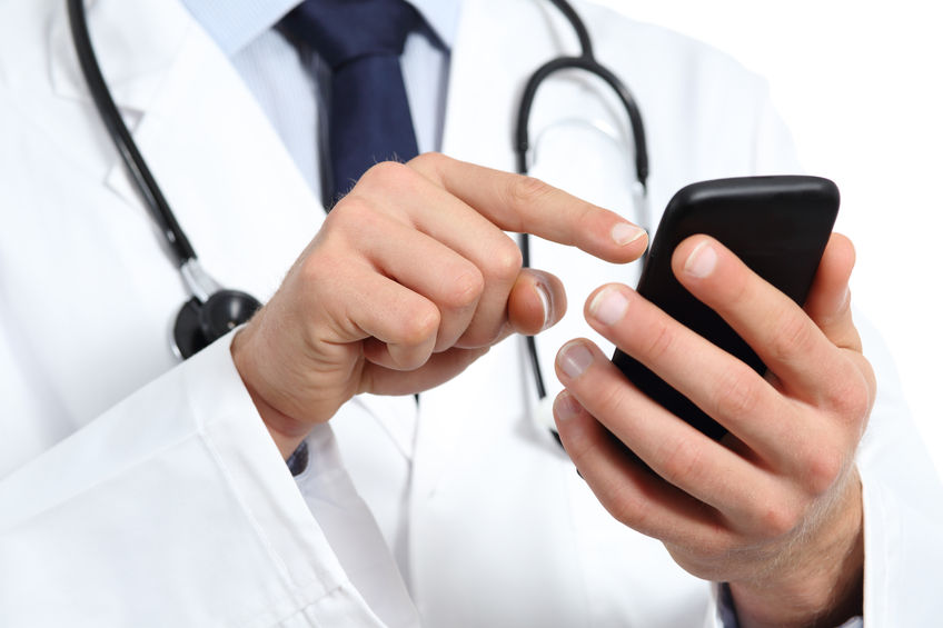 Doctor hands texting on a smart phone isolated on a white background